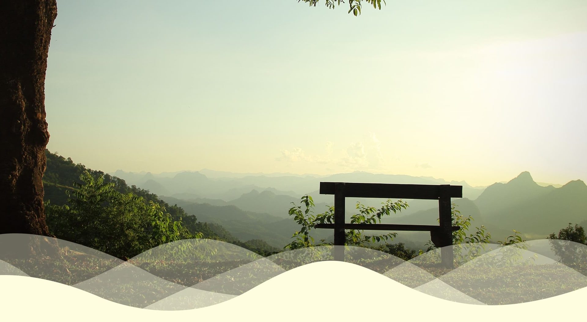A quiet bench overlooking a misty mountain landscape