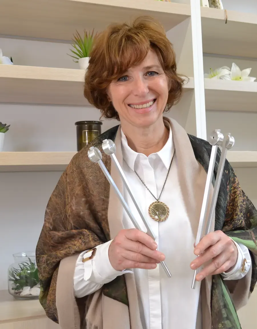 Branka Androjna holding tuning forks in her welcoming studio