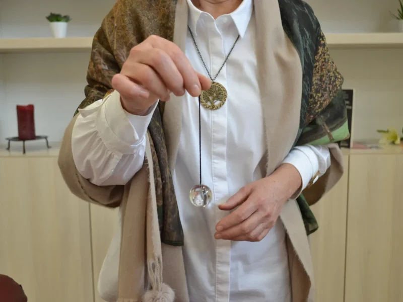 Milangela holding a pendulum during a guided meditation session