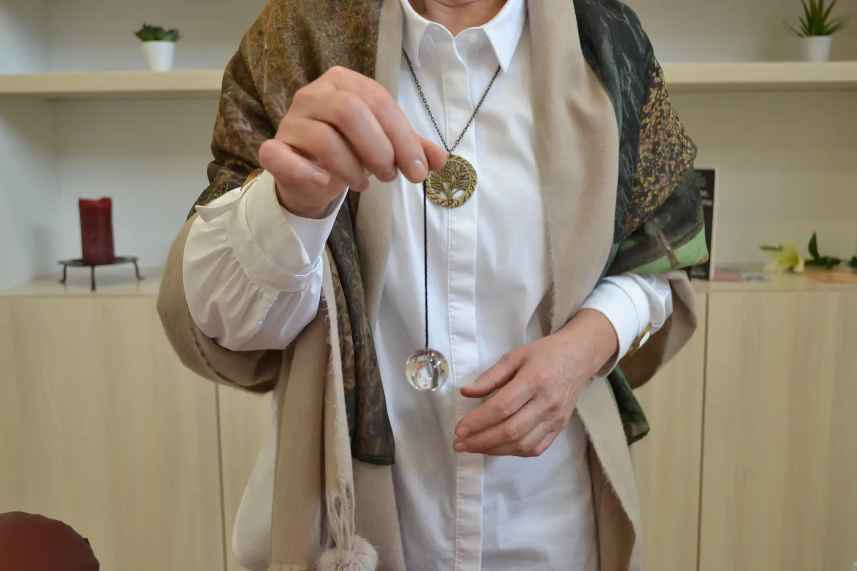 Milangela holding a pendulum during a guided meditation session